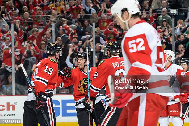 Kris Versteeg of the Chicago Blackhawks celebrates with teammates after scoring against the Detroit Red Wings to tie the game 2-2 in the third period...