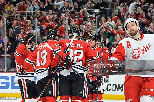 The Chicago Blackhawks celebrate behind Niklas Kronwall of the Detroit Red Wings, including Patrick Kane and Brad Richards, after scoring in the...