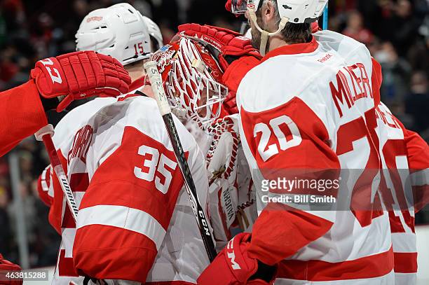 Goalie Jimmy Howard of the Detroit Red Wings celebrates after defeating the Chicago Blackhawks 3-2 during the NHL game at the United Center on...