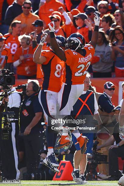 Jacob Tamme of the Denver Broncos celebrates his second quarter touchdown against the New England Patriots with C.J. Anderson during the AFC...