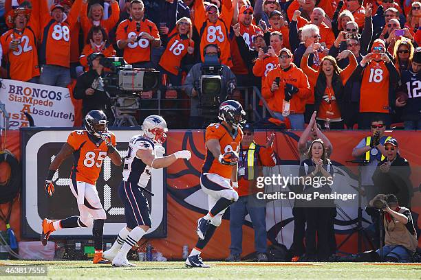 Jacob Tamme of the Denver Broncos scores a second quarter touchdown against the New England Patriots during the AFC Championship game at Sports...