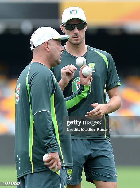 Coach Darren Lehmann gives some advice to Pat Cummins during an Australian training session at The Gabba on February 19, 2015 in Brisbane, Australia.