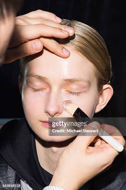 Model prepares before the Erin Fetherston show during Mercedes-Benz Fashion Week Fall 2015 at The Salon at Lincoln Center on February 18, 2015 in New...