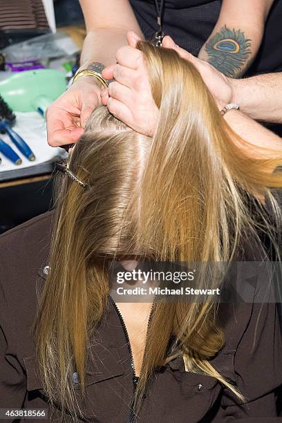 Model prepares before the Erin Fetherston show during Mercedes-Benz Fashion Week Fall 2015 at The Salon at Lincoln Center on February 18, 2015 in New...