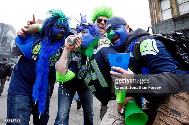 Seattle Seahawks fans drink a beer before the Seahawks take on the San Francisco 49ers in the 2014 NFC Championship at CenturyLink Field on January...