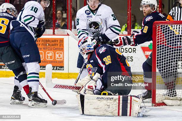 Goaltender Alex Fotinos of the Windsor Spitfires makes ahuge stick save against Vincent Scognamiglio of the Plymouth Whalers on February 18, 2015 at...