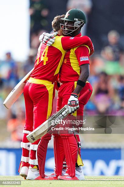 Sean Williams and Elton Chigumbura of Zimbabwe celebrate after winning the 2015 ICC Cricket World Cup match between Zimbabwe and the United Arab...