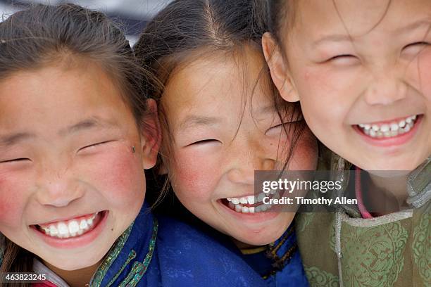 young mongolian sisters with laughing smiles - mongolian culture stock pictures, royalty-free photos & images