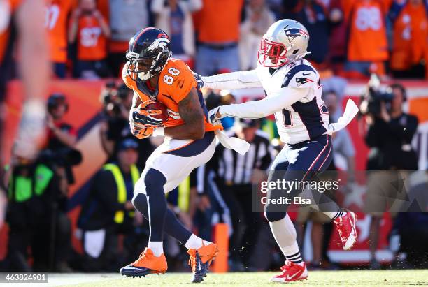 Demaryius Thomas of the Denver Broncos completes a third quarter touchdown reception against the defense of Alfonzo Dennard of the New England...