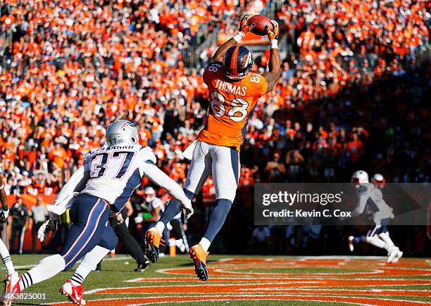 Demaryius Thomas of the Denver Broncos completes a third quarter touchdown reception against the defense of Alfonzo Dennard of the New England...