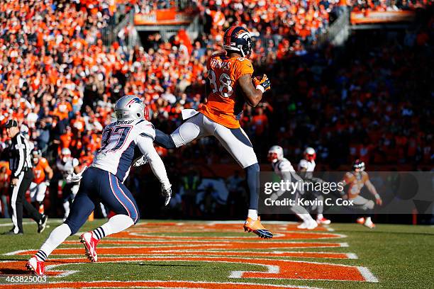 Demaryius Thomas of the Denver Broncos completes a third quarter touchdown reception against the defense of Alfonzo Dennard of the New England...