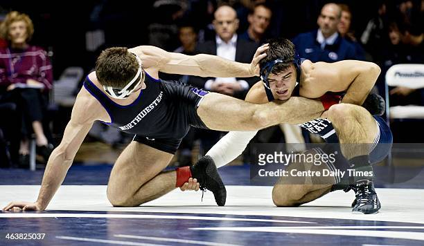 Northwestern's Alex Polizzi tries to get away from Penn State's Morgan McIntosh during the 197 lb bout at Rec Hall in State College, Pa., on Sunday,...