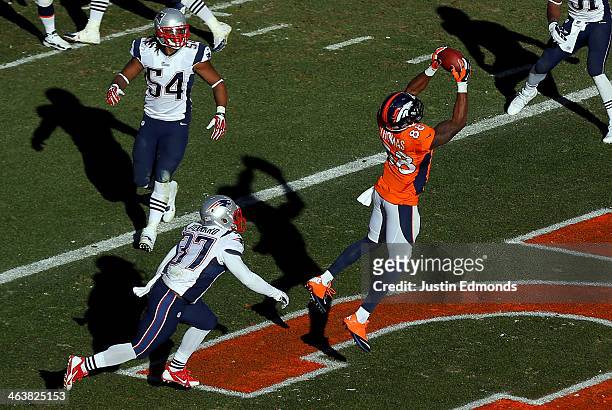 Demaryius Thomas of the Denver Broncos completes a third quarter touchdown reception against the defense of Alfonzo Dennard of the New England...