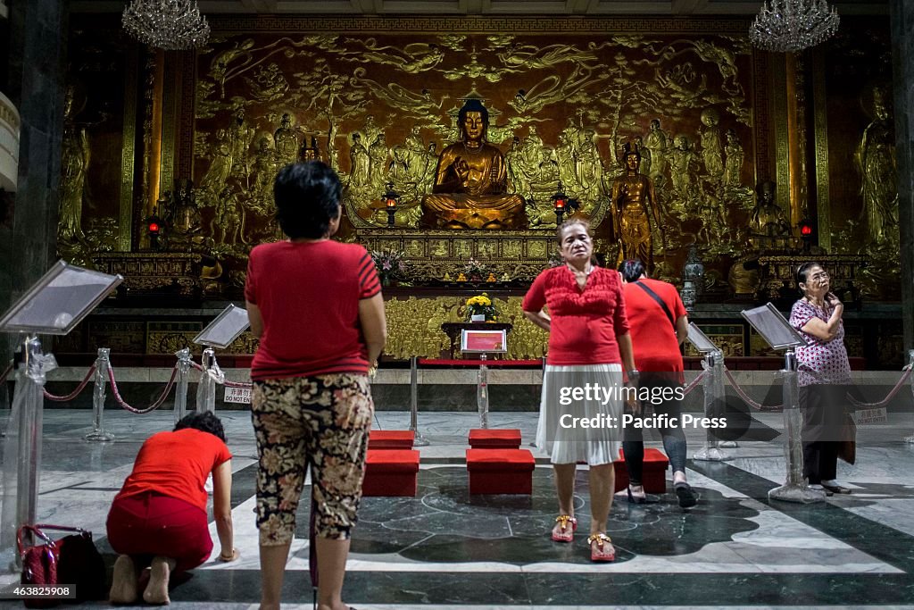 Visitors of the Buddhist Temple in Tondo, Manila offer their...