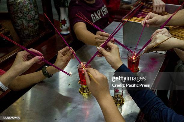 Visitors of the Buddhist Temple in Tondo light their incense as part of the rituals during the celebration of the Chinese New Year.