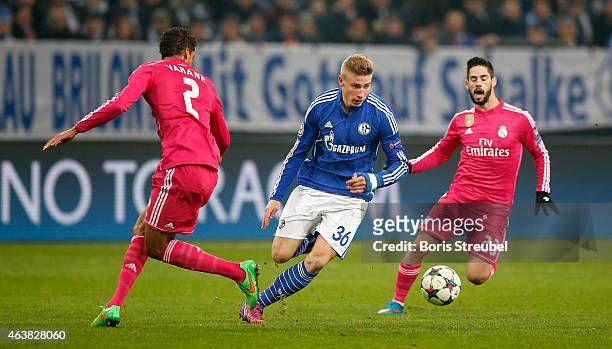 Raphael Varane and Isco of Real Madrid challenges Felix Platte of Schalke during the UEFA Champions League Round of 16 match between FC Schalke 04...