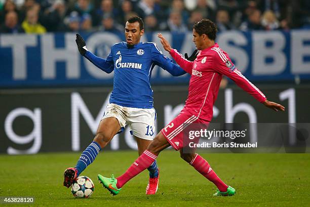 Raphael Varane of Real Madrid battles for the ball with Felix Platte of Schalke during the UEFA Champions League Round of 16 match between FC Schalke...