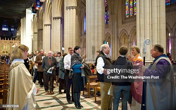 Long line forms at the National Cathedral to greet the new Episocal Bishop, Mariann Budde, second from right after services Sunday, November 13, 2011...