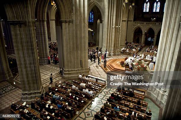 Congregants gather for communion from the new Episcopal Bishop Mariann Budde at National Cathedral which reopened to the public Sunday, November 13,...