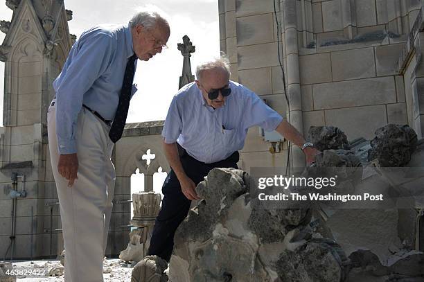 James Madison Cutts, consulting engineer, left, and architect Tony Segreti inspect a fallen pinnacle on the roof of the "Gloria in Excelsis" tower at...