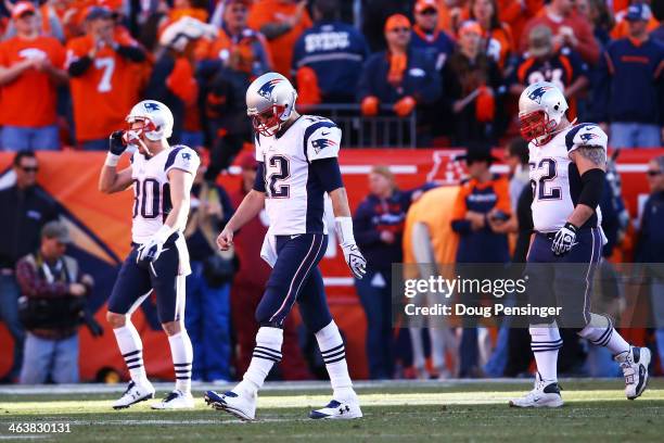 Tom Brady of the New England Patriots and his team walk off of the field after a failed two-point conversion in the fourth quarter against the Denver...