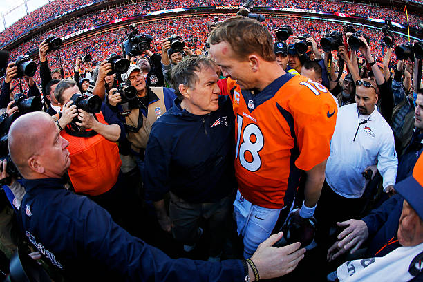 Head coach Bill Belichick of the New England Patriots congratulates Peyton Manning of the Denver Broncos after the Broncos defeated the New England...