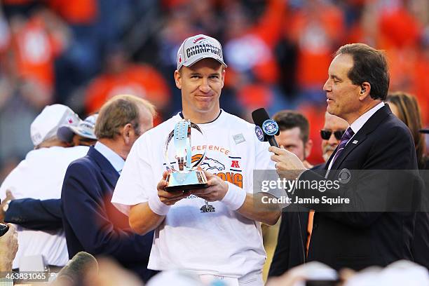 Peyton Manning of the Denver Broncos celebrates with the Lamar Hunt Trophy after they defeated the New England Patriots 26 to 16 in the AFC...