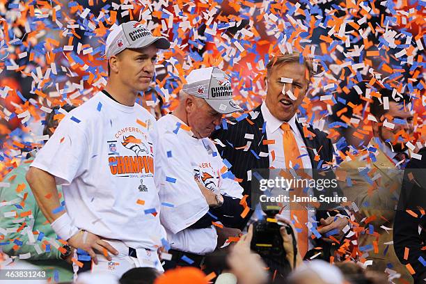 Peyton Manning, head coach John Fox and John Elway, executive vice president of football operations for the Denver Broncos, celebrate after they...
