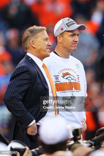 Peyton Manning and John Elway, executive vice president of football operations for the Denver Broncos, celebrate after they defeated the New England...