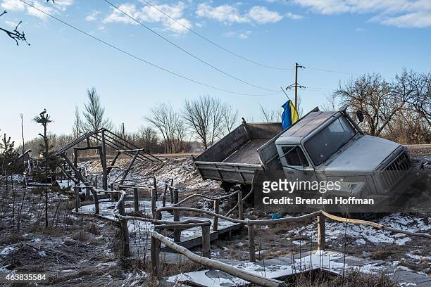 Ukrainian military truck lies in a ditch at the side of the road leading out of Debaltseve on February 19, 2015 in Artemivsk, Ukraine. Ukrainian...