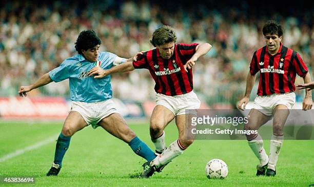 Napoli player Diego Maradona challenges Carlo Ancelotti of AC Milan during an Italian League match on October 21, 1990 in Naples, Italy.