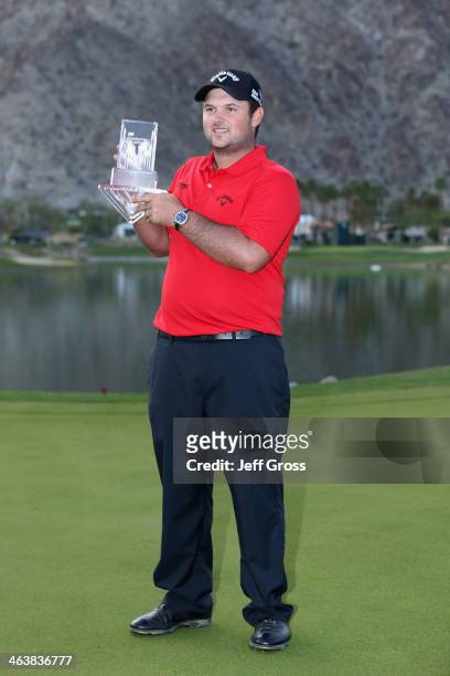 Patrick Reed poses with his trophy on the 18th green after winning the Humana Challenge in partnership with the Clinton Foundation on the Arnold...
