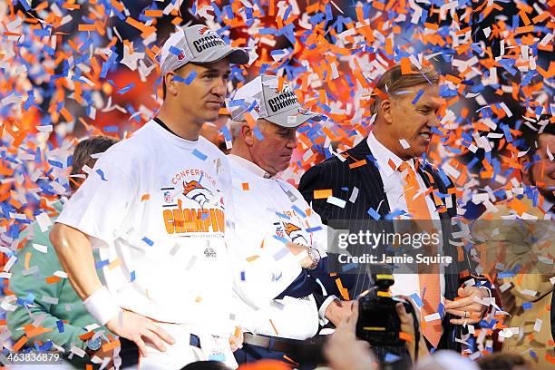 Peyton Manning, head coach John Fox and John Elway, executive vice president of football operations for the Denver Broncos, celebrate after they...