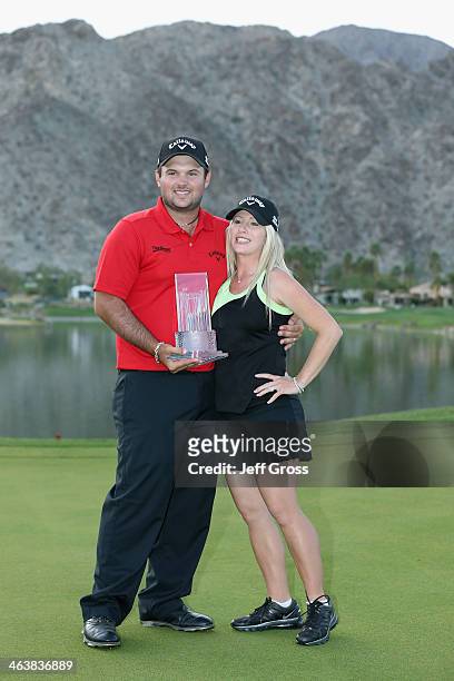 Patrick Reed and his wife Justine pose with his trophy after winning the Humana Challenge in partnership with the Clinton Foundation on the Arnold...