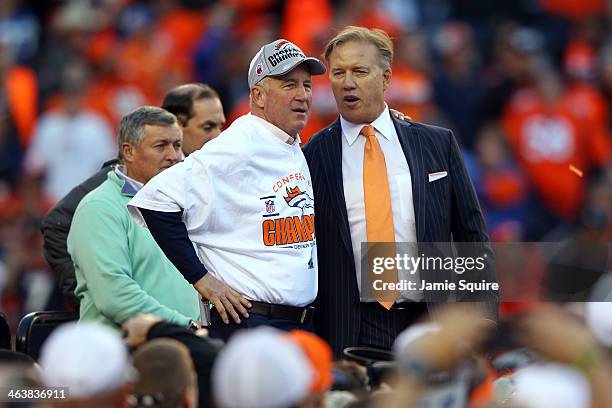 Head coach John Fox and John Elway, executive vice president of football operations for the Denver Broncos, celebrate after they defeated the New...