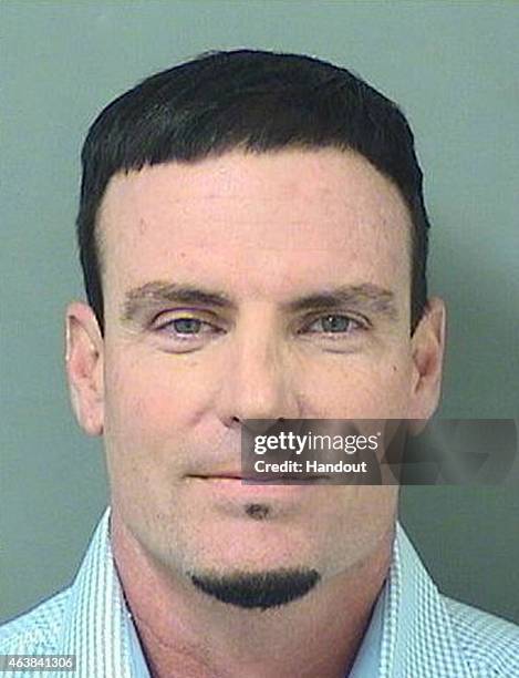 In this handout provided by the Palm Beach County Jail, Rapper Vanilla Ice, also known as Robert Van Winkle poses for his mugshot after being...