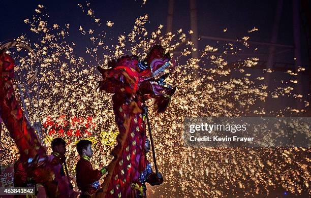 Chinese artists perform a dragon dance at a local amusement park during celebrations for the Lunar New Year February 19, 2015 in Beijing, China.The...