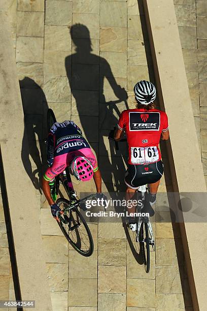 Race leader Fabian Cancellara of Switzerland and Trek Factory Racing passes Roberto Ferrari of Italy and Lampre-Merida as he rides to sign in for...