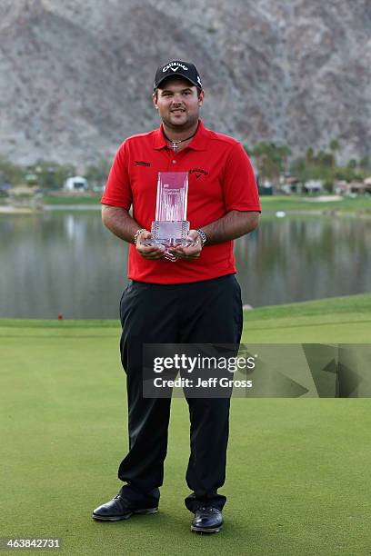 Patrick Reed poses with his trophy on the 18th green after winning the Humana Challenge in partnership with the Clinton Foundation on the Arnold...