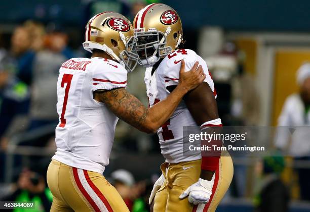 Quarterback Colin Kaepernick of the San Francisco 49ers celebrates with running back Anthony Dixon after Dixon scores a one-yard touchdown in the...