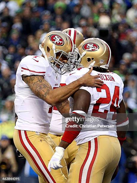 Quarterback Colin Kaepernick of the San Francisco 49ers celebrates with running back Anthony Dixon after Dixon scores a one-yard touchdown in the...