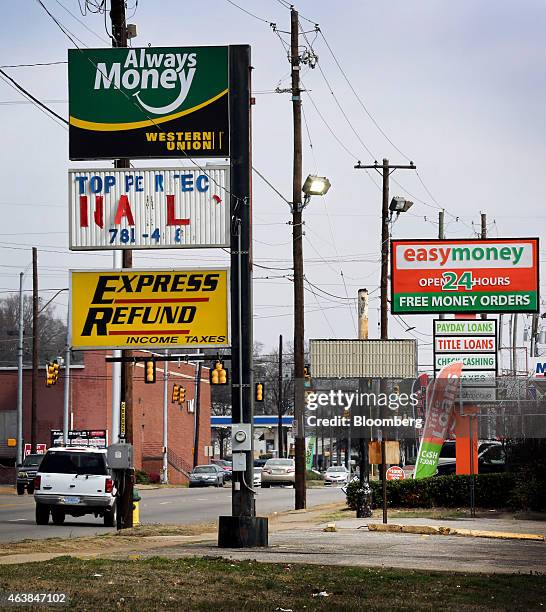 Signage advertising short-term loans stands in front of stores in Birmingham, Alabama, U.S., on Tuesday, Feb. 10, 2015. In Alabama, the sixth-poorest...