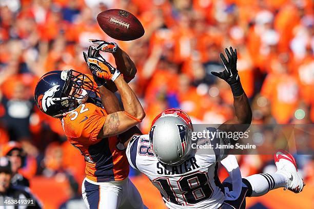 Tony Carter of the Denver Broncos breaks up a pass intended for Matthew Slater of the New England Patriots in the first quarter during the AFC...