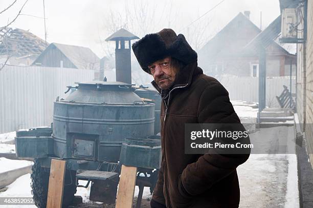 Local resident seeking help looks on as people from the ministry for civil defense and emergencies of the 'Donetsk People's Republic' set up a...