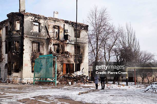 Local residents seeking help look on as people from the ministry for civil defense and emergencies of the 'Donetsk People's Republic' set up a...