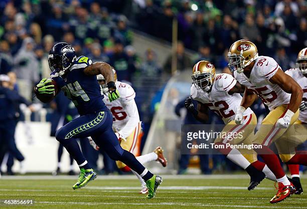 Running back Marshawn Lynch of the Seattle Seahawks runs for a 40-yard touchdown in the third quarter against the San Francisco 49ers during the 2014...