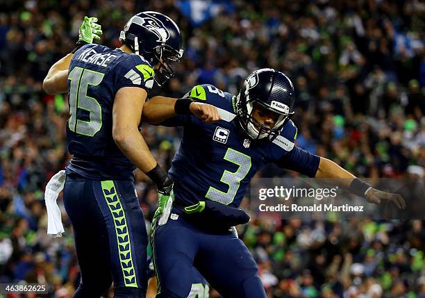 Wide receiver Jermaine Kearse of the Seattle Seahawks celebrates with quarterback Russell Wilson after Kearse catches a 35-yard touchdown in the...