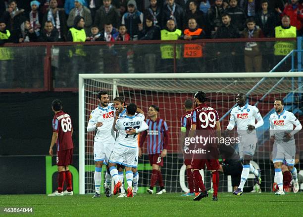 Napoli's Henrique Adriano Buss celebrates with teammates after scoring a goal on February 19, 2015 during the first-leg round of 32 UEFA Europa...