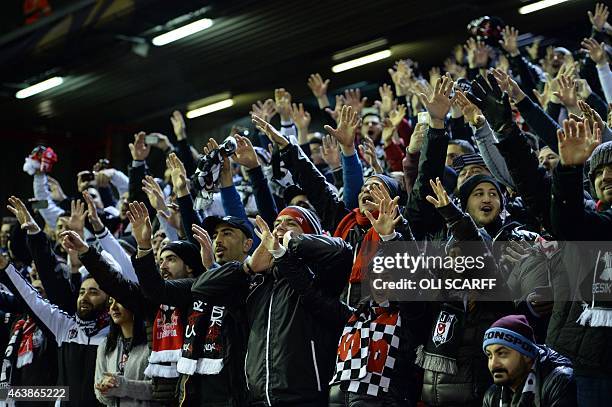 Besiktas fans chant before the UEFA Europa League round of 32 first leg football match between Liverpool and Besiktas at Anfield in Liverpool,...