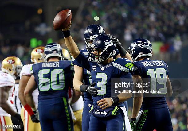 Quarterback Russell Wilson of the Seattle Seahawks celebrates as the Seahawks defeat the San Francisco 49ers 23-17 during the 2014 NFC Championship...
